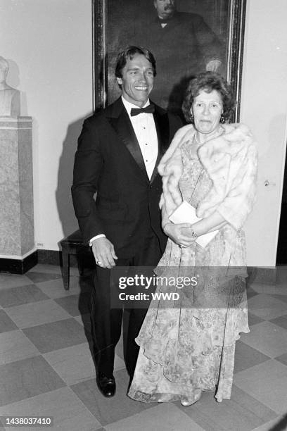 Outtake; Actor Arnold Schwarzenegger in a tuxedo accompanying his mother, Aurelia to a White House Dinner to celebrate Argentinian President Raul...