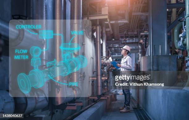 male engineer working with steel pipelines and valves at industry factory - valvola di sfiato foto e immagini stock