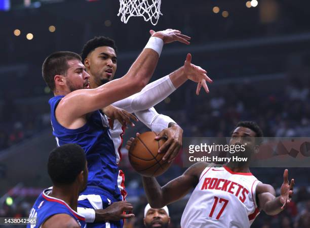 Kenyon Martin Jr. #6 of the Houston Rockets and Ivica Zubac of the LA Clippers go for a rebound in front of Tari Eason during the first half at...