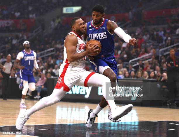 Eric Gordon of the Houston Rockets drives to the basket on Paul George of the LA Clippers during the first half at Crypto.com Arena on October 31,...