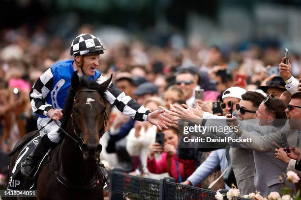 Mark Zahra riding Gold Trip celebrates with spectators after winning race seven, the Lexus Melbourne Cup during 2022 Melbourne Cup Day at Flemington...