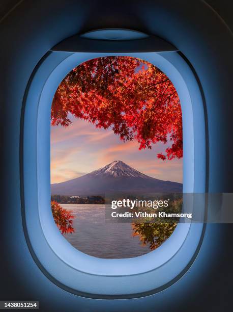 airplane windows with aerial view of mount fuji volcano famous place at japan - fugaku stock-fotos und bilder