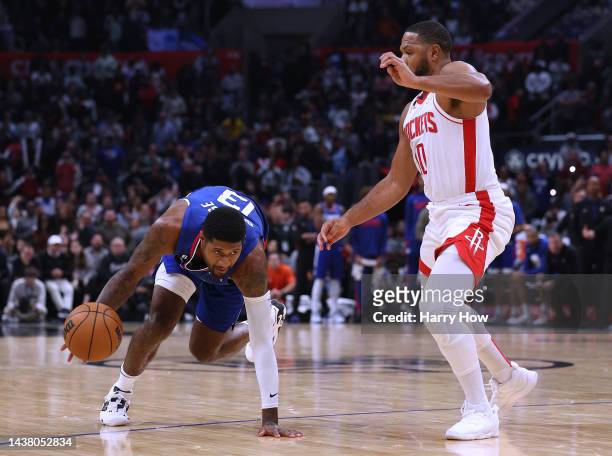 Paul George of the LA Clippers falls as he drives the basket on Eric Gordon of the Houston Rockets to take the shot giving the Clippers a 95-93 lead...