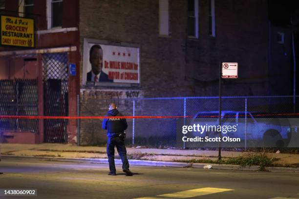 Police investigate the scene where as many as 14 people were reported to have been shot on October 31, 2022 in Chicago, Illinois. Three juveniles...