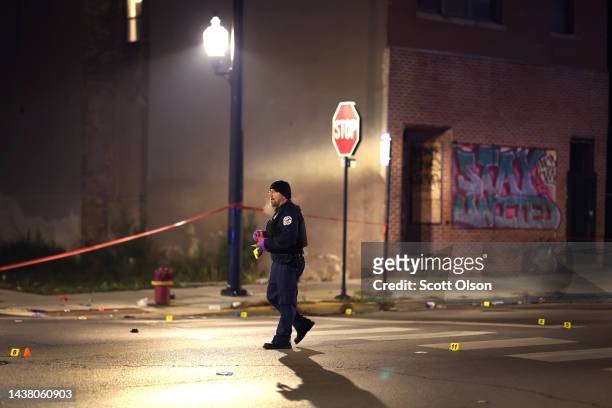 Police investigate the scene where as many as 14 people were reported to have been shot on October 31, 2022 in Chicago, Illinois. Three juveniles...