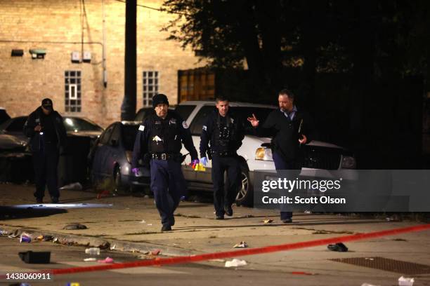 Police investigate the scene where as many as 14 people were reported to have been shot on October 31, 2022 in Chicago, Illinois. Three juveniles...