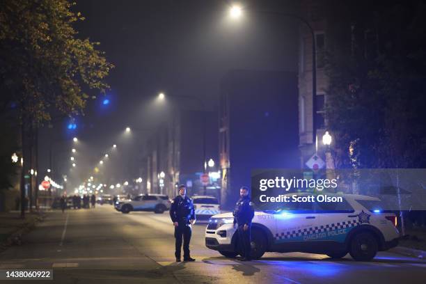 Police investigate the scene where as many as 14 people were reported to have been shot on October 31, 2022 in Chicago, Illinois. Three juveniles...