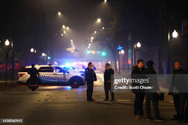 Police investigate the scene where as many as 14 people were reported to have been shot on October 31, 2022 in Chicago, Illinois. Three juveniles...