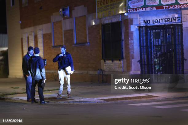 Police investigate the scene where as many as 14 people were reported to have been shot on October 31, 2022 in Chicago, Illinois. Three juveniles...