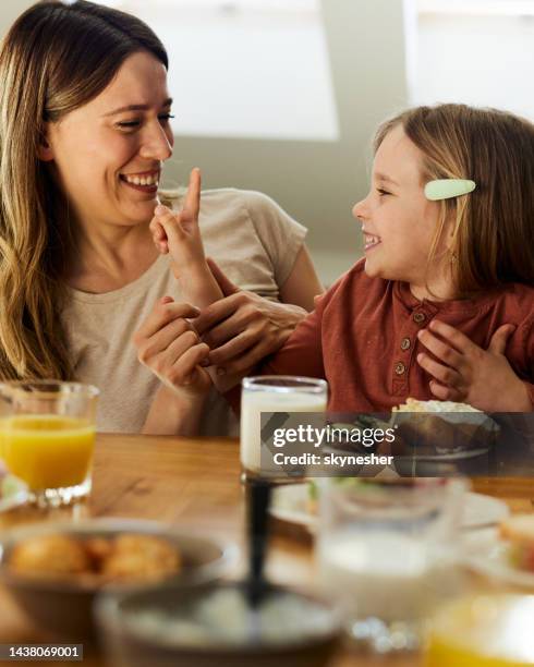 happy single mother and daughter enjoying in breakfast at home. - breakfast table stock pictures, royalty-free photos & images