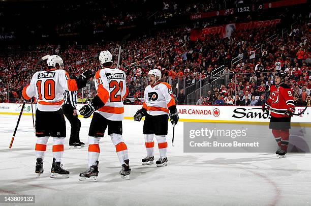 Brayden Schenn of the Philadelphia Flyers celebrates with teammates James van Riemsdyk and Danny Briere after scoring a goal against Martin Brodeur...