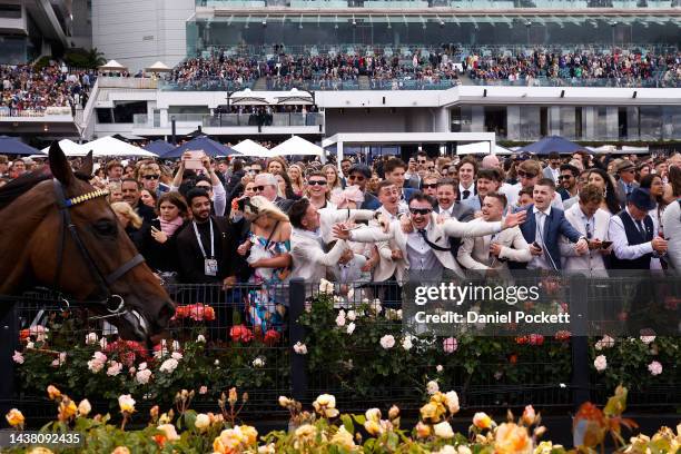 Racegoers celebrate after race seven, the Lexus Melbourne Cup during 2022 Lexus Melbourne Cup Day at Flemington Racecourse on November 01, 2022 in...