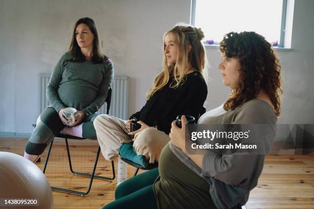 circle of pregnant women at birth preparation workshop - birthing chair stock pictures, royalty-free photos & images