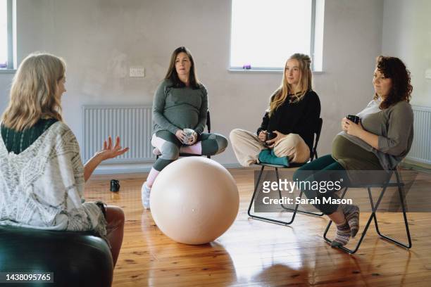 pregnant women sat at birth preparation workshop - birthing chair stock pictures, royalty-free photos & images
