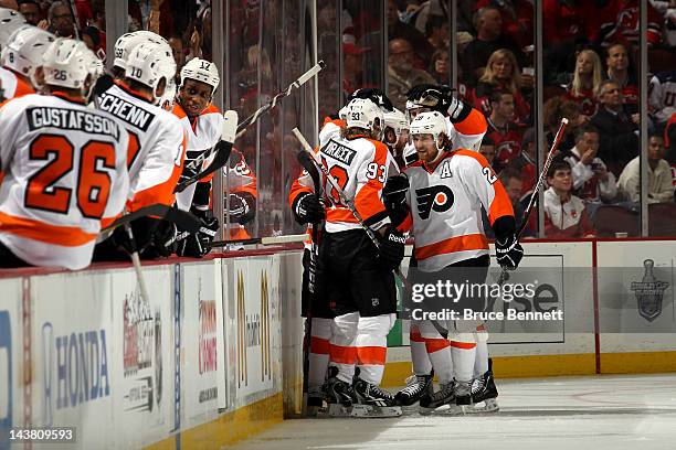 Matt Carle of the Philadelphia Flyers celebrates with his teammates after scoring a goal in the second period against Martin Brodeur of the New...