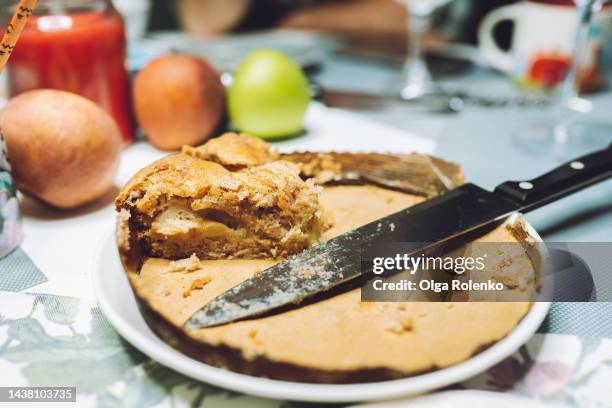 last slice of pie on thanksgiving day. one piece of fruit pie on plate on the table - apple cake stock pictures, royalty-free photos & images