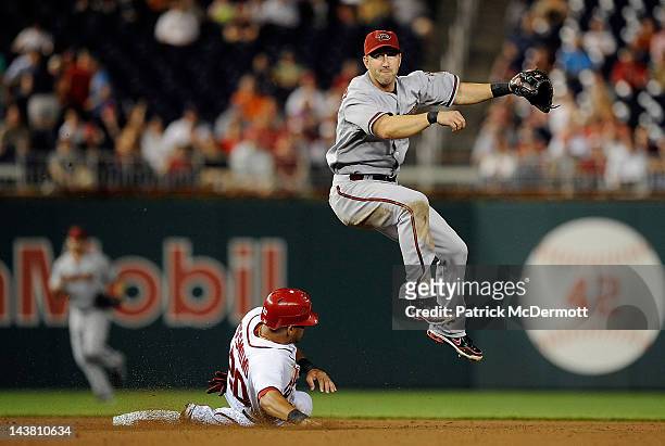 Ian Desmond of the Washington Nationals slides into second base as Willie Bloomquist of the Arizona Diamondbacks turns a double play in the eighth...