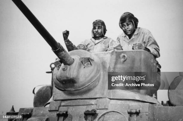 Recruits in the turret of an tank during training at Montford Point, near Camp Lejeune, Jacksonville, North Carolina, April 1943. The first African...