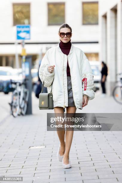 Federrock founder and influencer Anna von Schilcher, wearing a bordaux turtleneck by The Outnet, a beige oversized bomber jacket by The Outnet &...