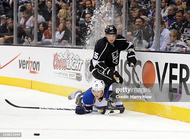 Oshie of the St. Louis Blues lies on the ice next to Slava Voynov of the Los Angeles Kings in the third period in Game Three of the Western...