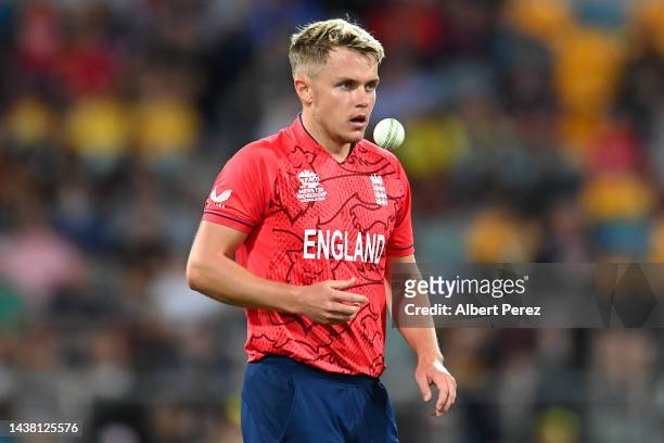 Sam Curran of England tosses the ball before bowling during the ICC Men's T20 World Cup match between England and New Zealand at The Gabba on...