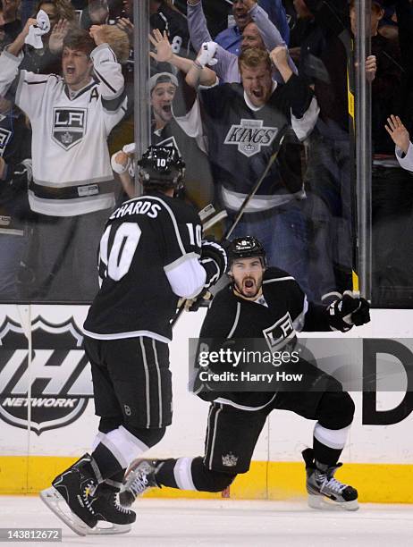 Drew Doughty of the Los Angeles Kings celebrates his third period goal with teammate Mike Richards against the St. Louis Blues in Game Three of the...