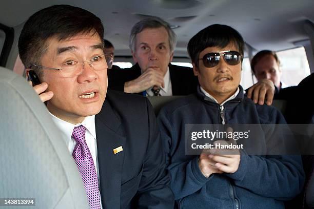 In this handout photograph provided by the U.S. Embassy Beijing press office, Chinese dissident Chen Guangcheng looks on as U.S. Ambassador to China...