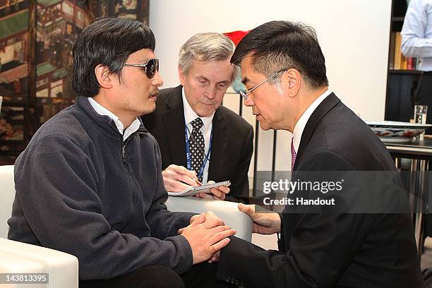 In this handout photograph provided by the U.S. Embassy Beijing press office, Chinese dissident Chen Guangcheng talks with U.S. Ambassador to China...