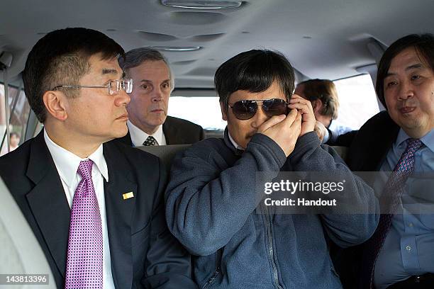 In this handout photograph provided by the U.S. Embassy Beijing press office, Chinese dissident Chen Guangcheng speaks on a phone as U.S. Ambassador...