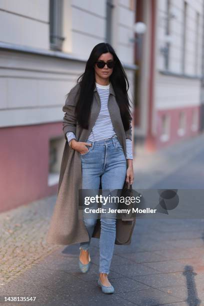 Leo Eberlin seen wearing Chanel denim ballerinas, a Max Mara beige cashmere coat, a Hermes Kelly 25 brown leather bag, a COS white and blue striped...