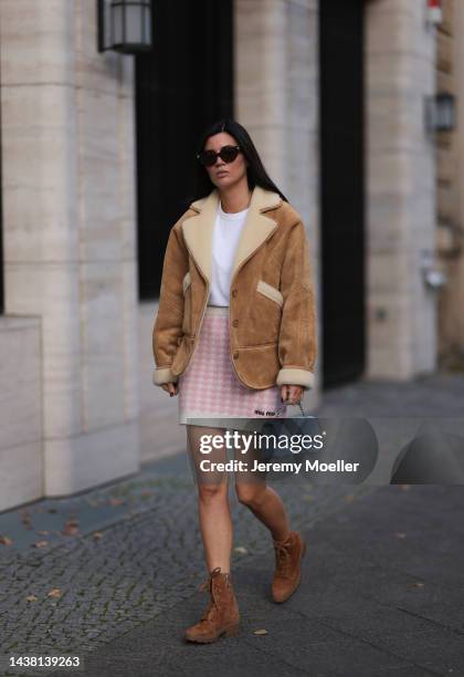 Leo Eberlin seen wearing a MiuMiu knit checked white rose mini skirt, Revolve brown wild leather boots, Leo Mathild jewelry, an Uniqlo white shirt, a...