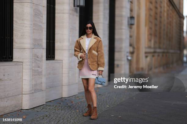 Leo Eberlin seen wearing a MiuMiu knit checked white rose mini skirt, Revolve brown wild leather boots, Leo Mathild jewelry, an Uniqlo white shirt, a...