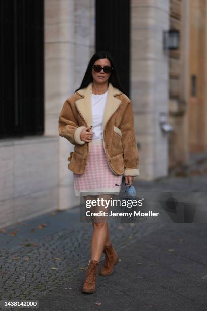 Leo Eberlin seen wearing a MiuMiu knit checked white rose mini skirt, Revolve brown wild leather boots, Leo Mathild jewelry, an Uniqlo white shirt, a...