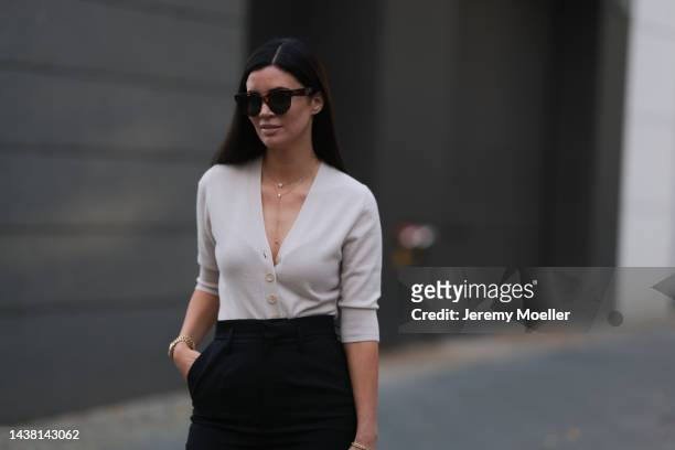 Leo Eberlin seen wearing an Allude x Leo Mathild beige body, Yves Saint Laurent black suit pants, Leo Mathild jewelry and Celine brown shades on...