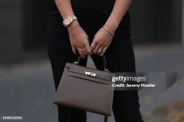 Leo Eberlin seen wearing Yves Saint Laurent black suit pants, Leo Mathild jewelry and a Hermes brown leather 25 Kelly bag on October 30, 2022 in...