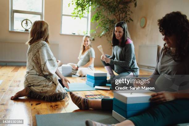 pregnant women sat on floor in birth preparation workshop - yoga prop stock pictures, royalty-free photos & images