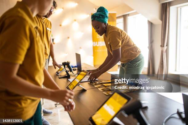 hotel workers preparing a reception for a business conference - business cards on table stock pictures, royalty-free photos & images