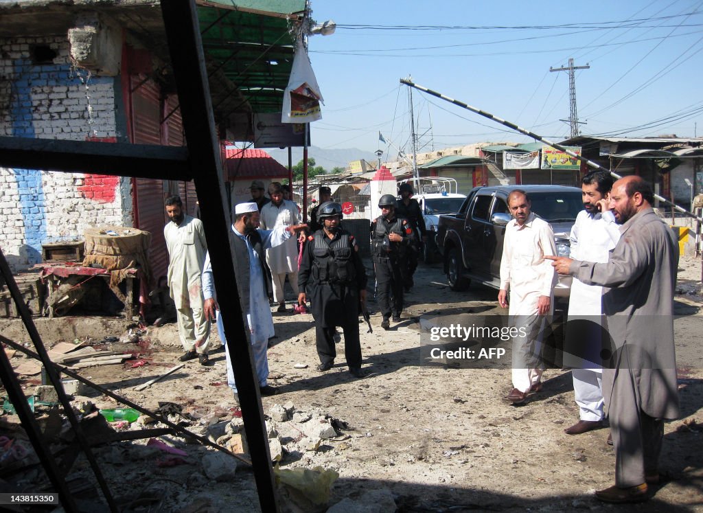 Pakistani security officials examine the