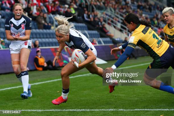 Tara-Jane Stanley of England breaks through to score their team's second try during the Women's Rugby League World Cup Group A match between England...