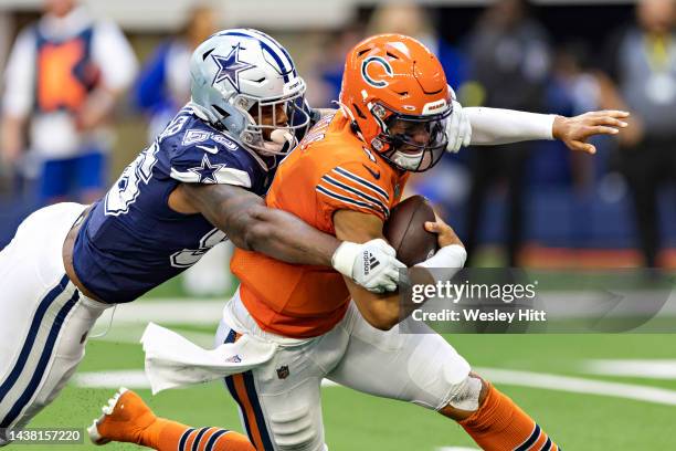 Justin Fields of the Chicago Bears is tackled by Dante Fowler of the Dallas Cowboys at AT&T Stadium on October 30, 2022 in Arlington, Texas. The...