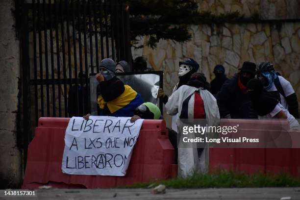Demonstrators hold a sign in support of political prisoners in Bogota, Colombia amid the liberation of political prisoners captured during the last...