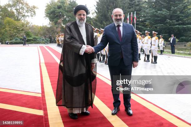 Iranian President Ebrahim Raeesi and Armenian Prime Minister Nikol Pashinyan look on during the official welcome of the Prime Minister of Armenia to...