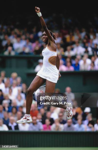 Venus Williams from the United States jumps in the air in celebration after defeating Martina Hingis of Switzerland in their Women's Singles...