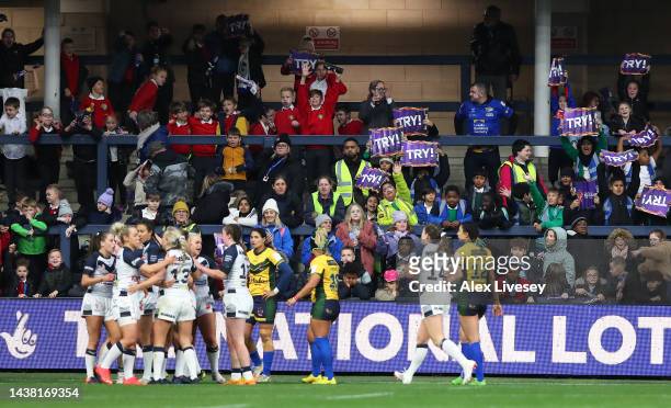 Fans cheer after Leah Burke of England touches down for their team's twelfth try during the Women's Rugby League World Cup Group A match between...