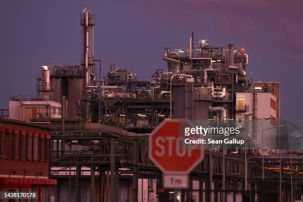 The BASF plant stands at sunset behind a stop sign on November 01, 2022 in Schwarzheide, Germany. The plant, which makes chemical products, relies on...
