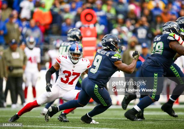 Kenneth Walker III of the Seattle Seahawks runs the ball against Fabian Moreau of the New York Giants during the second half of the game at Lumen...