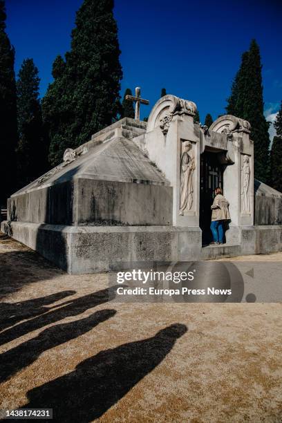 Woman enters the Pantheon of the Dukes of Denia in the Sacramental Cemetery of San Isidro de Madrid, on November 1 in Madrid, Spain. It is the oldest...