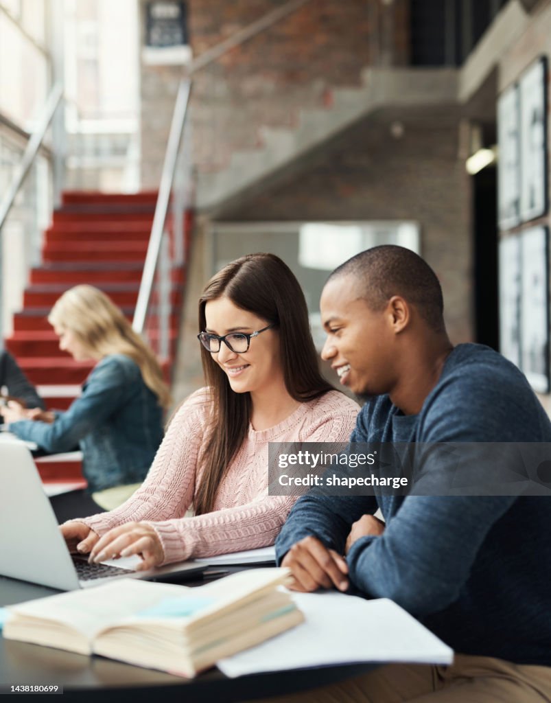 Student, working and study friends together with a computer using technology for university research. Scholarship, education and college library test learning of a black man and woman with a laptop