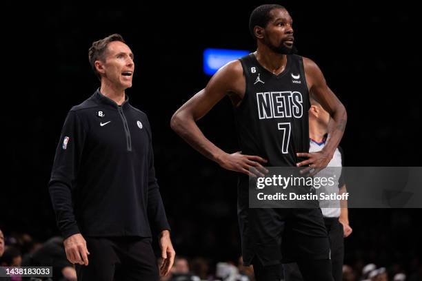 Head coach Steve Nash and Kevin Durant of the Brooklyn Nets look on during a break in the action during the third quarter of the game against the...