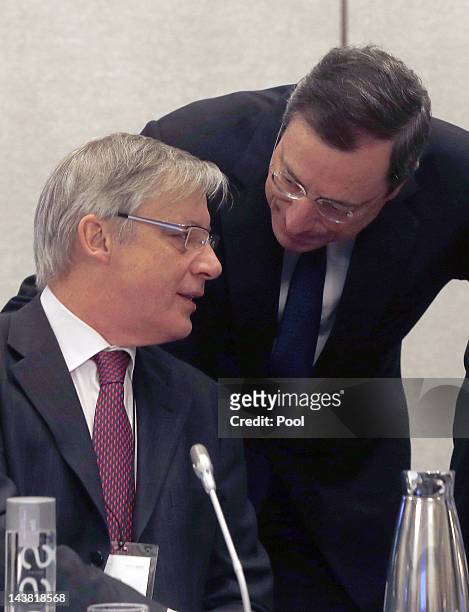 President of the European Central Bank, Mario Draghi, talks with The President of the Bank of France, Christian Noyer, before an ECB council meeting...